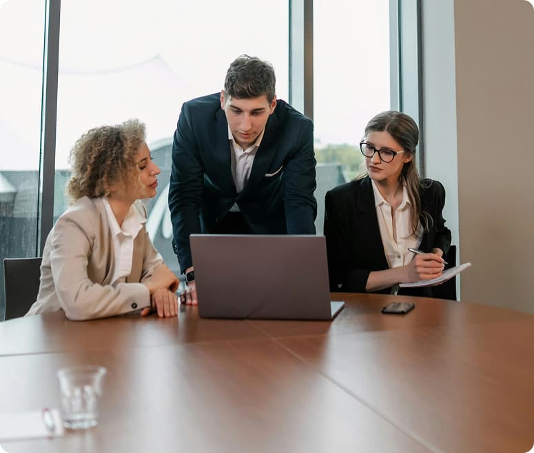 Colleagues reviewing work together at a desk