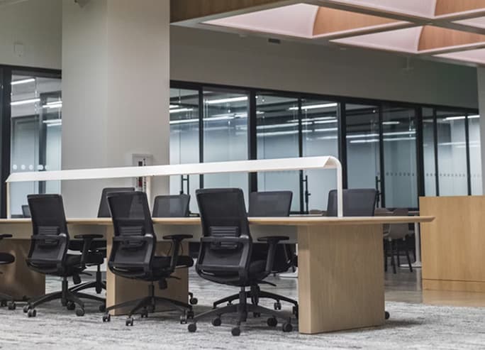 A meeting room with desks and office chairs